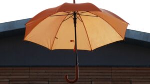 an orange umbrella on a roof