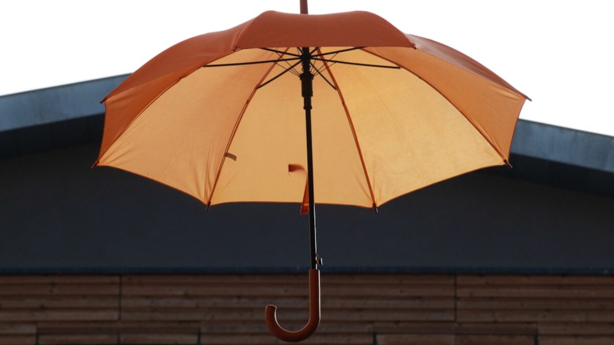 an orange umbrella on a roof