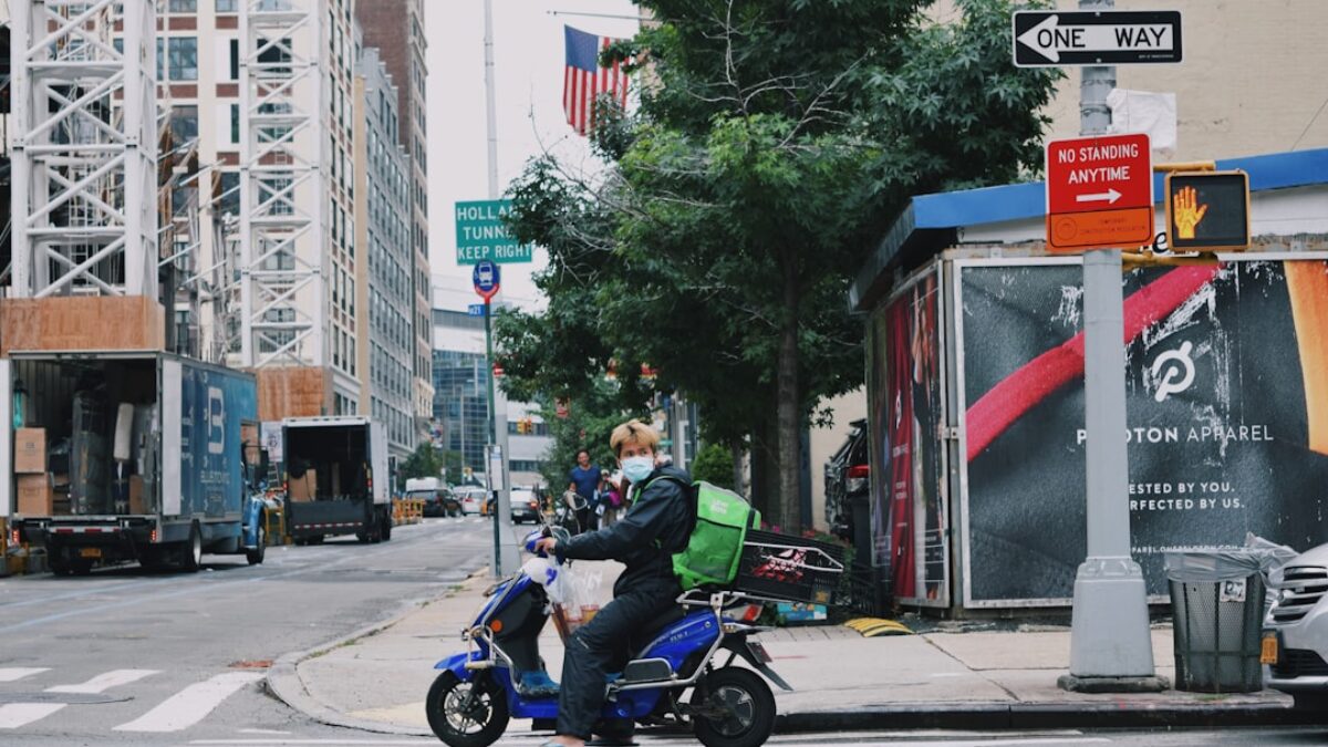 a man riding a scooter on a city street