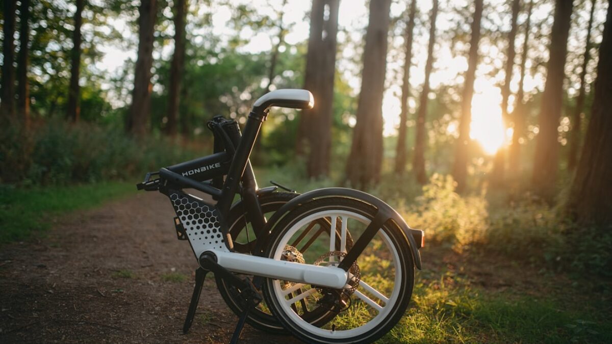 a bicycle parked on a trail in the woods