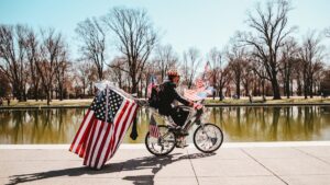 2 men riding on bicycle on road during daytime