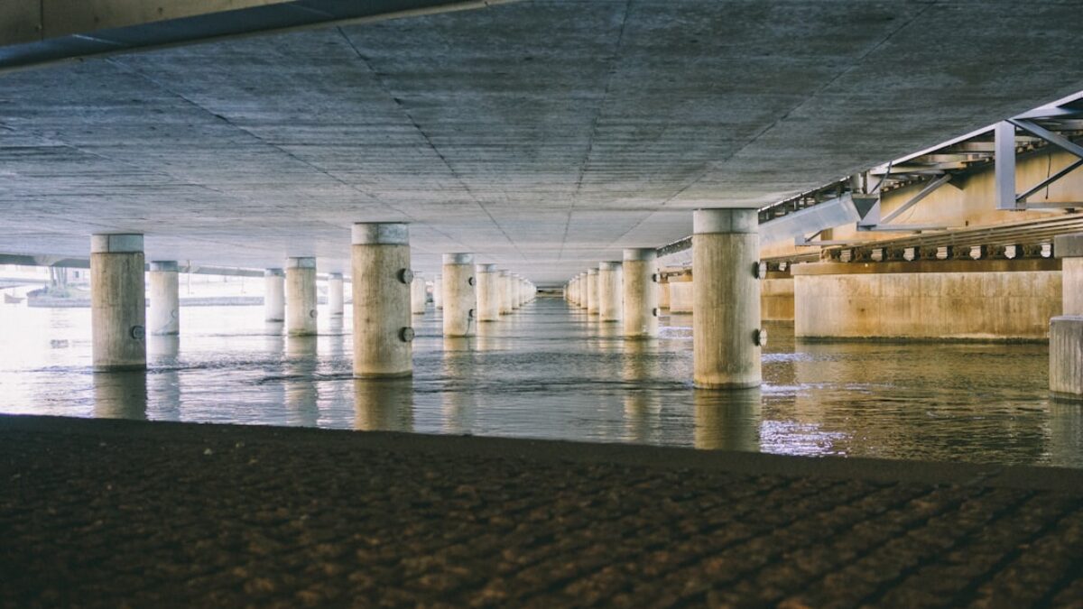 white pillars supporting concrete roof