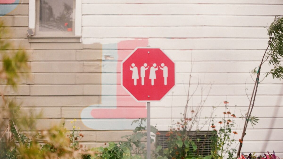 red and and white signage near white wall